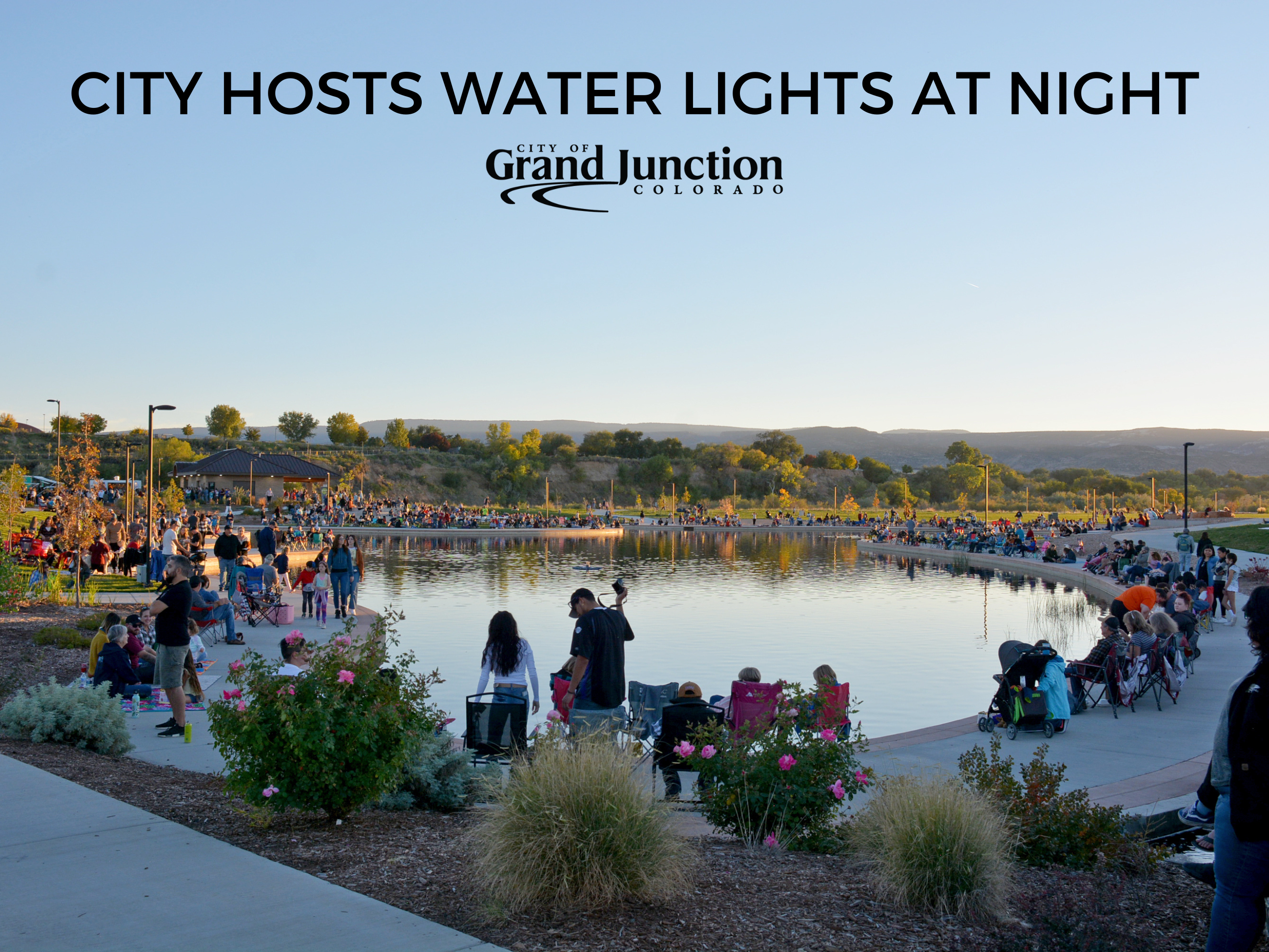 Crowd gathers around Butterfly Pond in Grand Junction at sunset