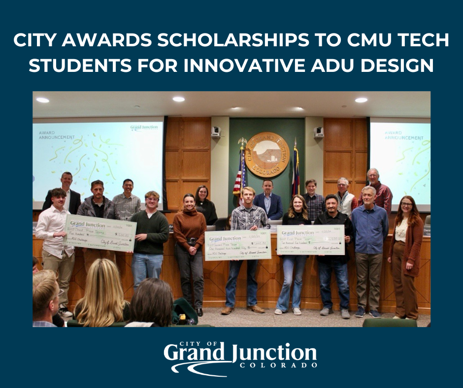 Group of CMU Tech students gather at the front of City Council chambers with large checks.