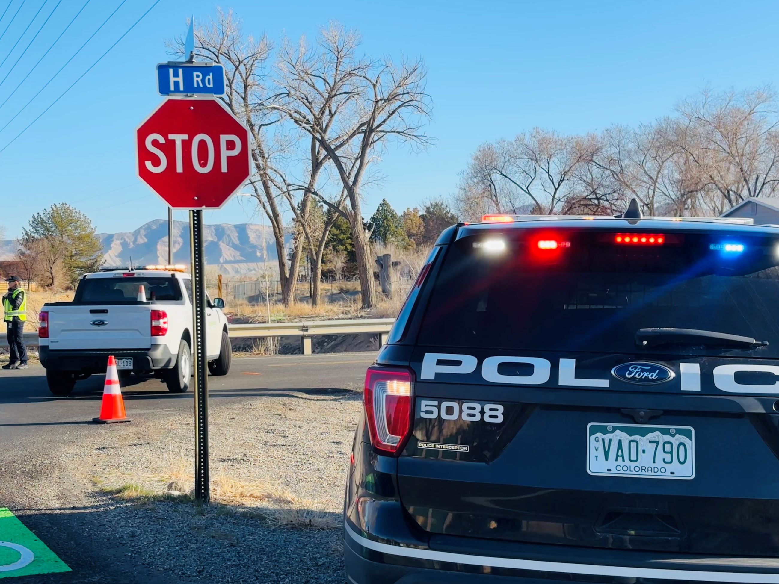 GJPD patrol vehicle next to stop sign at H Road