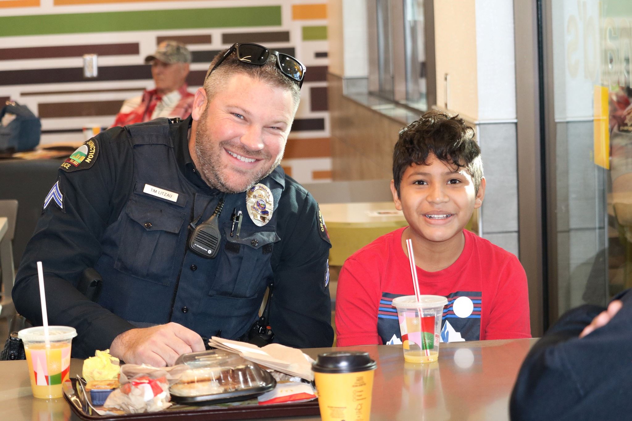 Officer eating breakfast with a child