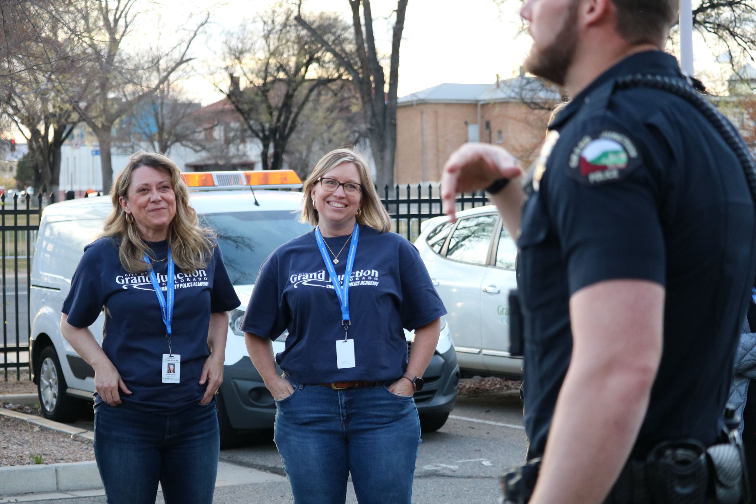 Two women smiling at police officer