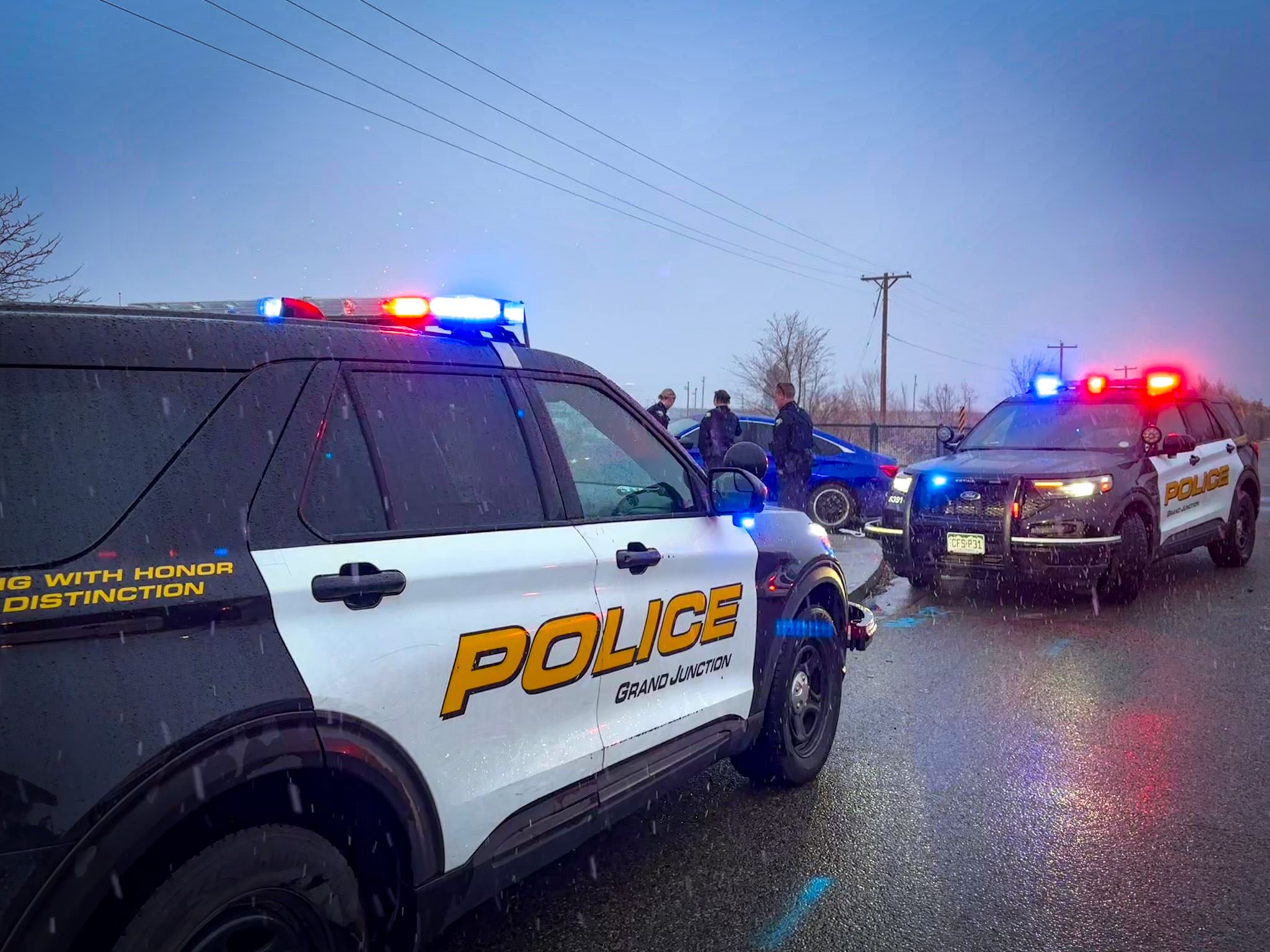 Two GJPD patrol cars and three officers on scene of crash